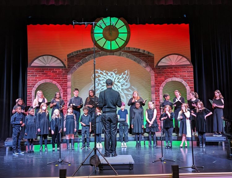 Greensboro Youth Chorus performs a holiday concert in 2022 on the stage of the Virginia Somerville Sutton Theatre