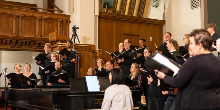 Bel Canto members laugh during a pause in dress rehearsal