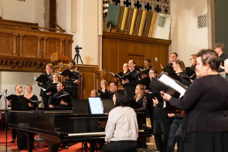 Bel Canto members laugh during a pause in dress rehearsal