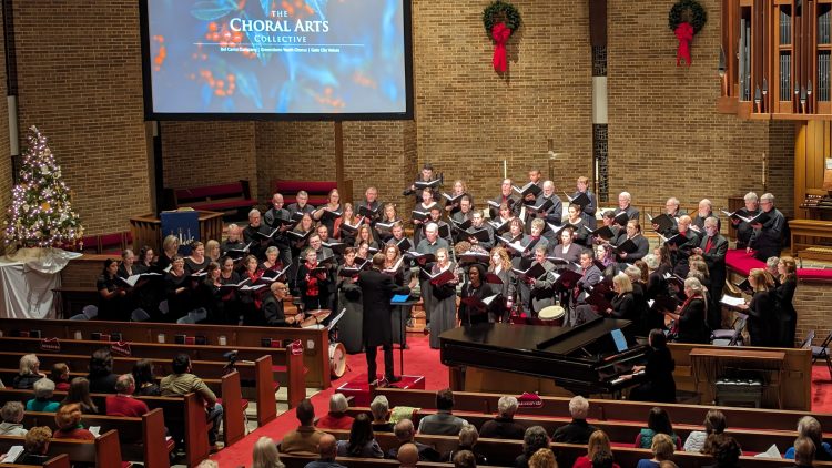 Bel Canto Company and Gate City Voices perform at Christ United Methodist Church with wreaths and festive decorations on the walls