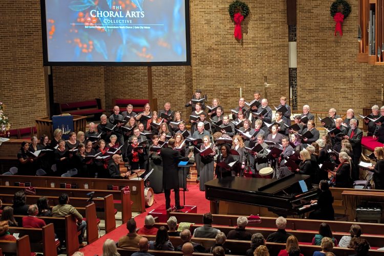 Bel Canto Company and Gate City Voices perform at Christ United Methodist Church with wreaths and festive decorations on the walls