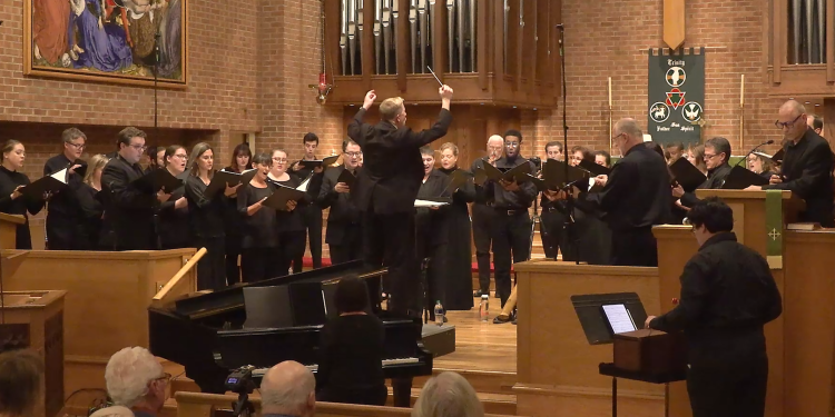 Welborn Young conducts Bel Canto Company at Ebenezer Lutheran Church in 2023 as the audience looks on in the foreground