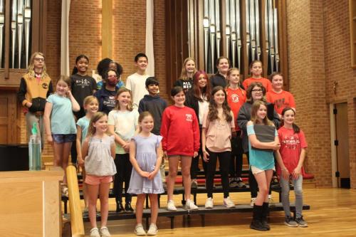 Greensboro Youth Chorus performing with Wheatmore High School Choir in a church sanctuary 